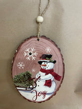 Load image into Gallery viewer, Snowman Wood looking ornament that lights up.
