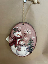 Load image into Gallery viewer, Snowman Wood looking ornament that lights up.
