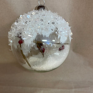 Glass ornament with snow
